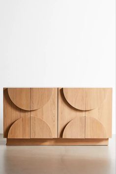 the sideboard is made out of wood and has two circles on it, as well as an oval design