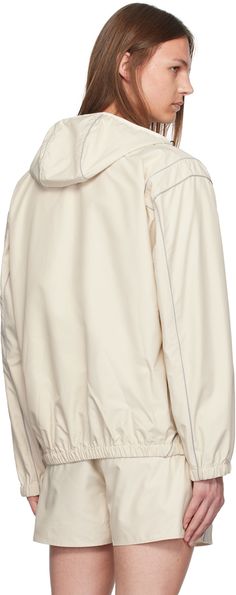 Nylon taffeta jacket. Reflective piping throughout. · Bungee-style drawstring at hood · Zip closure · Welt pockets · Elasticized hem and cuffs · Full mesh lining Supplier color: Ivory Cream Hooded Nylon Outerwear, Cream Nylon Hooded Outerwear, White Nylon Track Jacket With Drawstring Hood, White Nylon Windbreaker With Detachable Hood, White Hooded Nylon Parka, Hooded Nylon Outerwear With Elastic Cuffs, White Nylon Windbreaker With Double-lined Hood, Cream Hooded Windbreaker For Outdoor, Sporty White Outerwear With Drawstring