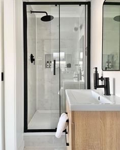 a bathroom with a sink, shower and mirror