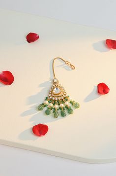 Elevate your style with this stunning maangtikka, expertly crafted with polki and cubic zirconia to create a traditional statement piece. The intricate design includes dangling green jade stones and pearls, adding a touch of elegance to any outfit. Perfect for enhancing your look with sophistication and charm, this maangtikka is a must-have accessory. Finish: 22KT Gold Plating Material: Silver, Copper Alloy, Polki, CZ Color: Green Size: One Size Closure Type: Hook Box Contains: 1 Maangtikka Hand Jewelry Rings, Chain Braid, Artificial Jewelry, Jewelry Indian, Jade Stone, Hand Jewelry, Anklet Jewelry, Green Jade, Charm Gift