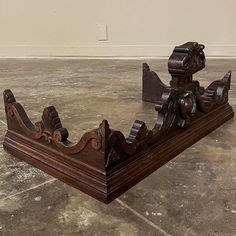 an antique wooden boat is sitting on the floor