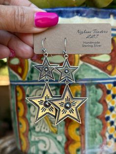 Be unique and stylish with the Star Gazer Dangle Earrings! Offering an eye-catching western look, these earrings have the perfect mix of chic and statement style. Make a memorable style statement with this unique jewelry! Stamped Sterling Silver 2.5 " L X 1.5" W Non-Native Unique Dangle Linear Earrings, Bohemian Star-shaped Nickel-free Earrings, Bohemian Silver Star-shaped Earrings, Bohemian Silver Star Earrings, Southwestern Style Metal Drop Earrings, Handmade Star-shaped Festival Earrings, Handmade Star Earrings For Festivals, White Bin, Horse Hair Pottery