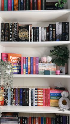 a white book shelf filled with lots of books