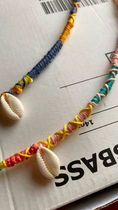 two seashells are on a string attached to a paper with the word ssvg