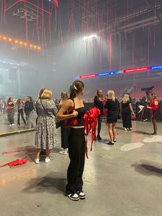 some people are standing in a circle with red streamers