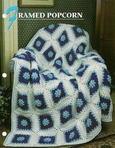 a blue and white afghan sitting on top of a chair