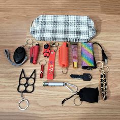 the contents of a purse laid out on a wooden table with scissors, keys, and other items