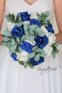 a bride holding a blue and white bouquet