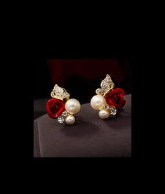 Indulge in the breathtaking beauty of our Red Rose Crystal Rhinestone Earrings! These elegant earrings feature a stunning rose flower design adorned with sparkling crystal rhinestones and delicate pearl accents. Elevate any outfit and make a bold statement with these one-of-a-kind earrings. Don't hesitate to add a touch of romance and glamour to your wardrobe. Order now and fall in love with these exquisite earrings! Rose Flower Design, Rose Crystal, Breathtaking Beauty, Bag Icon, Sparkling Crystal, Accessories Jacket, Rhinestone Earrings, Elegant Earrings, Red Rose