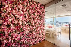 a large flowered wall in the middle of a dining room with tables and chairs