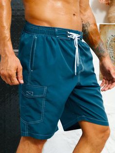 Stay organized and stylish with our Flap Pocket Swim Trunks. These swim trunks feature convenient flap pockets, providing storage for your essentials while on the beach or at the pool. The waistband offers a comfortable fit, and the quick-drying fabric ensures optimal comfort in and out of the water. Features: Color: Blue Pattern Type: Plain Details: Drawstring, Pocket Type: Bottoms Bottom Type: Shorts Fabric: Non-Stretch Care Instructions: Machine wash, do not dry clean Body: Lined Sheer: No Si Summer Sports Shorts With Cargo Pockets, Summer Nylon Swim Trunks With Side Pockets, Outdoor Bottoms With Pockets For Beach Season, Nylon Beach Bottoms With Side Pockets, Casual Swimwear With Side Pockets For Beach Season, Beach Bottoms With Side Pockets In Nylon, Casual Swimwear With Side Pockets For Beach, Summer Functional Bottoms With Pockets, Functional Summer Bottoms With Pockets