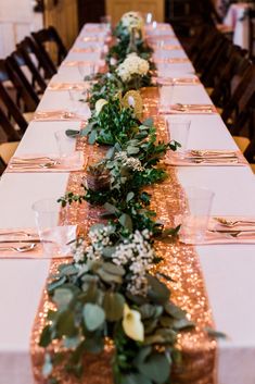 the long table is decorated with gold sequins and greenery