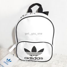 Adidas Originals Santiago Mini Backpack Bag White/Black 9.5" NEW Represent the 3-Stripes with the small, compact design of the adidas Originals Santiago Mini Backpack! It features a spacious main storage compartment and front zip pocket for your smaller essentials. Top carry handle and adjustable backpack straps Front zip pocket for additional storage. Logo at front pocket and top. Bag and lining are constructed of 100% polyester. Dimensions: 6.75" x 4.5" x 9.5" Ships from smoke-free, pet-free location. Please note, shipping address cannot be altered after purchase has occurred. Prior to final purchase please ensure that address reflects the final shipping address. International Buyers Please Note: Import duties, taxes, and charges are not included in the item price or shipping cost. These Storage Logo, Backpack Bag, Backpack Straps, Mini Backpack, White Bag, Compact Design, Backpack Bags, Adidas Originals, Front Pocket