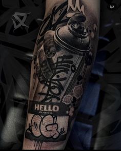 a man with a tattoo on his arm holding a can of hello kitty inked onto it