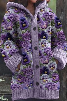 a woman wearing a purple flowered coat