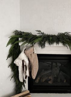 a fireplace with stockings hanging from it's mantle