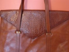 Bruno Magli rich cognac leather tote, brief case, travel 15 3/4 " x 11 3/4" x 3".  One owner lightly use, vintage late 1980's been stored...excellent excellent condition. Normal wear for vintage that can be easily polished at bottom corners..very slight sign of wear. See interior photos that show zip pocket, authentic label.  Very finely made and in fine condition.   Selling Bruno Magle snake and other leather shoes in great condition. Also three piece ladies leather bolero jacket, skirt & pants! Please see other bruno magli one owner items being sold as well as Gucci & Dooney Bourke bags.   no returns Vintage Leather Tote Briefcase, Vintage Leather Briefcase Tote, Classic Formal Bag In Brandy Color, Classic Brandy-colored Bag For Formal Occasions, Classic Brandy-colored Formal Bag, Vintage Cognac Briefcase, Vintage Cognac Briefcase For Everyday, Vintage Cognac Briefcase For Travel, Vintage Brown Rectangular Briefcase For Formal Use