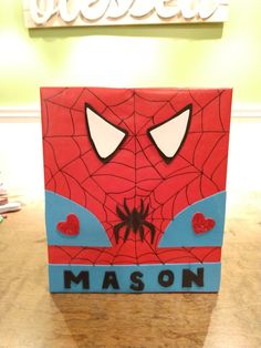 a close up of a cardboard box with a spiderman face on it's side