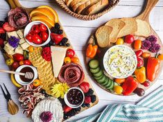 two wooden trays filled with different types of food on top of a white table