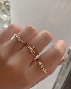 Mei features a beautiful stacking ring with 4mm clear cubic zirconia on a thin gold-filled band. She's easy to stack with other rings but can also be worn on her own as she catches every glistening light. She's made in 14k gold fill which makes her tarnish-resistant, showerproof, and safe for sensitive skin. Just keep her away from chemicals such as hand sanitizer, soap, and lotion. …………………………………. D E T A I L S • Available from US 5 to 8• Keep away from chemicals such as lotion, soap, and hand s Cute Rings Aesthetic Simple, Mum Diy, Pearl Stacking Ring, Dainty Gold Jewelry, Hand Rings, Stacker Rings, Gold Rings Simple, Dainty Gold Rings, S Jewelry