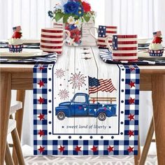 an american flag table runner with a blue truck and red white and blue decorations on it