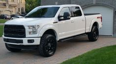 a white truck parked in front of a house