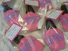 pink and blue decorated cookies in plastic wrappers with name tags on each one side