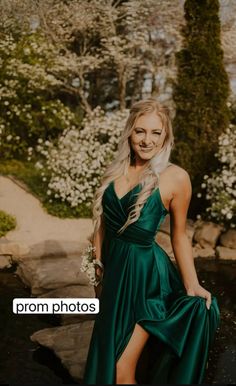 a woman in a long green dress posing for a photo with her hand on her hip