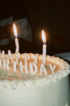 a birthday cake with lit candles on it