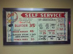 a restaurant menu hangs on the wall in front of a sign that says self service