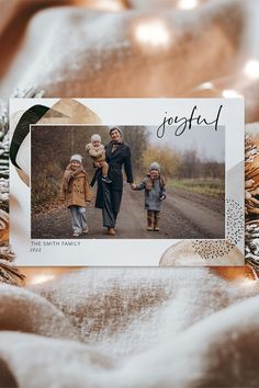 a christmas card with an image of three children walking down the road in front of them