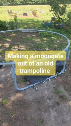 an old trampoline in the middle of a field with a sign reading making a moongate out of an old trampoline