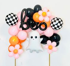 balloons and decorations are arranged in the shape of numbers, with a ghost standing between them