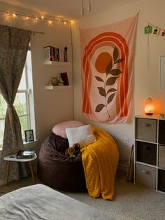 a bed room with a large poster hanging above it's headboard and pillows on the floor