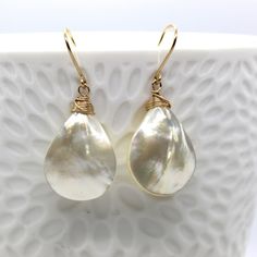 "Super lusterous white mother of pearl Earrings. Handmade 14 kt gold fill earwire and wire wrapped teardrop shape.  Available in 14 kt Gold fill, sterling silver or 14 kt Rose gold fill. Teardrop is about 1 1/4\" long and 3/4\" wide." Teardrop 14k Gold-filled Pearl Earrings For Anniversary, Teardrop 14k Gold Filled Pearl Earrings For Anniversary, 14k Gold Filled Teardrop Pearl Earrings For Anniversary, Elegant Nickel-free 14k Gold-filled Teardrop Earrings, Briolette Pearl Drop Teardrop Earrings For Gift, Briolette Teardrop Pearl Drop Earrings For Gift, Pearl Drop Briolette Teardrop Earrings, Briolette Teardrop Pearl Earrings As Gift, Gift Briolette Teardrop Earrings With Pearl Drop