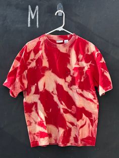 This up-cycled bleached Red Pocketed T-Shirt is a must have. It is hand-dyed, one of a kind, and super super soft. If there is a specific vintage T-shirt/sweatshirt that you are looking for that you have not been able to find please let us know! We would love to help you track it down. This shirt is sized as a ADULT M - Shirt measurements available upon request ONLY 1 IN STOCK - One of a Kind CARE INSTRUCTIONS Try to avoid bleach and fabric softeners Wash inside out in cold water Tumble dry low Acid Wash Cotton T-shirt With Natural Dye, Vintage Tie Dye Washed T-shirt, Vintage Washed Tie-dye T-shirt, Vintage Tie Dye Tops, Relaxed Fit Tie-dye T-shirt With Natural Dye, Vintage Style Hand Dyed Short Sleeve T-shirt, Vintage Hand-dyed Short Sleeve T-shirt, Vintage Hand Dyed Cotton T-shirt, Vintage Tie Dye Hand Dyed T-shirt