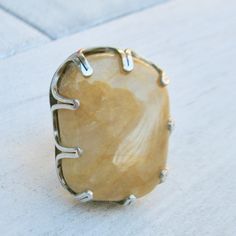 "Yellow quartzite beach gem from Maidstone Beach in East Hampton. The stone came here with the last ice age glaciers! It is set in a \"crown\" setting on a silver ring. Size is 6.5 US but it can be enlarged. The stone measures about 1.5 x 1 x 0.5 inches. For the beach lover in you!" Agate Jewelry With Large Stone For Anniversary, Anniversary Jewelry With Large Agate Stone, Adjustable Sterling Silver Crystal Ring With Large Stone, Large Round Citrine Stone Jewelry, Large Stone Citrine Jewelry For Anniversary, Round Citrine Jewelry With Large Stone, Citrine Jewelry With Large Stone For Anniversary, Citrine Ring With Large Stone, Adjustable Large Stone Moonstone Ring In Sterling Silver