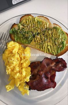 the plate has eggs, toast and bacon on it