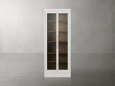 an empty bookcase with glass doors on the front and side, against a gray wall