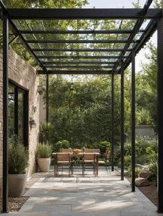 an outdoor dining area with tables and chairs under a pergolated roof, surrounded by greenery