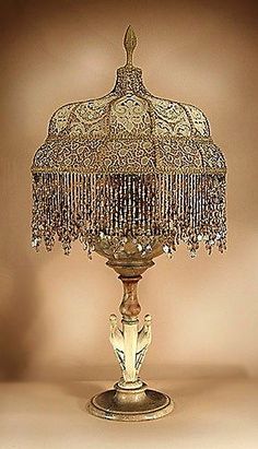 an ornate table lamp with beads on it