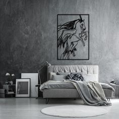 a bed sitting in a bedroom next to a painting on the wall