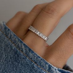 a woman's hand with a diamond ring on it