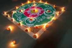 a decorated rangdi with candles on the ground