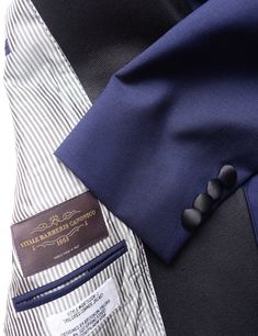 When you want to stand out a little at a black-tie function, this wool/mohair tuxedo in ink blue has you covered. The crisp fabric drapes beautifully, and the vibrant navy color will allow you to stand out in a sea of black tuxes. FABRIC AND TRIMS: 73% Wool 27% Mohair woven in Italy by Vitale Barberis Canonico Medium weight SEASONALITY: Suitable for year-round use in most climates COLOR: Ink Blue - A rich, vibrant blue. Slightly brighter than navy blue. BUTTONS: Covered in accent fabric ACCENT F Winter Black Tuxedo With Pressed Crease, Winter Black Tie Tuxedo With Notch Lapel, Black Wool Tuxedo Blazer, Luxury Single Breasted Outerwear For Black Tie, Luxury Single-breasted Outerwear For Black Tie, Luxury Fitted Navy Tuxedo, Luxury Wool Tuxedo With Concealed Placket, Black Wool Tuxedo With Suit Collar, Fitted Wool Tuxedo With Hidden Button Closure