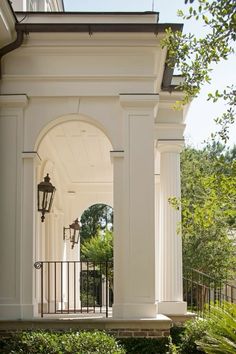 the front entrance to a house with columns