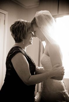 two women are touching each other in black and white