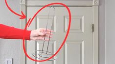 a person holding a glass in front of a door with an arrow pointing to it