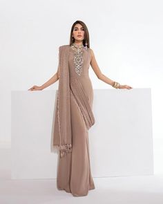 Saadia Mirza on Instagram: "Vestido Drapeado Tantalize this season in our pure crepe-draped saree embellished with an intricate placement of stones and sequins over the neckline, all of this magnificence comes together to put out a glamorous look. The subtlety of Vestido Drapeado is emboldened by the regal color of the ensemble creating a majestic outlook for any occasion. Concept: Saadia Mirza Model: @amnababer Photographer: @aleehassanphotographe Makeup: @fatimanasirmua René - Luxury Pret Desi Party, Draped Saree, Upscale Fashion, Luxury Pret, Asymmetrical Shirt, Raw Silk Fabric, Glamorous Look, Drape Saree, Buy Dresses Online