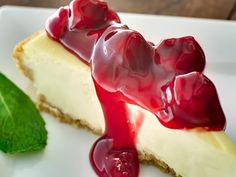 a piece of cheesecake with cherries on top